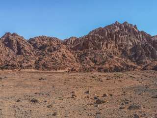 Martian landscape in Echo Valley near Sharm El Sheikh, Egypt. Orange-brown bare stone mountains in...