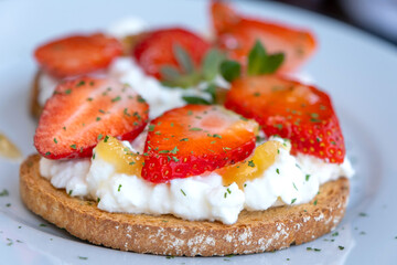 Healthy toast with strawberry, cottage cheese and honey. Tasty breakfast. Clean eating, dieting or recipe of healthy snack sandwich for vegetarian. Summer morning, breakfast or snack. Summer appetizer