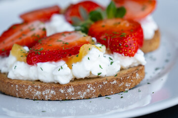 Healthy toast with strawberry, cottage cheese and honey. Tasty breakfast. Summer appetizer