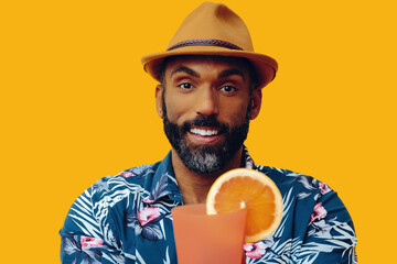 happy bearded mid adult african american man wearing Hawaiian shirt and hat smiling offering orange...