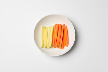 Vegetable sticks. Fresh carrot on white plate . Diet and Healthy snack food.