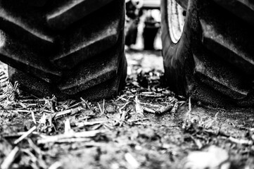 Soil compaction caused by a dual tractor tires over topsoil dirt in an empty field before planting.