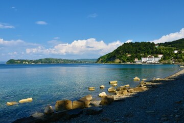 Adriatic sea coast in Slovenia with the cliff of Strunjan and a hotel at Fiesa bay near Piran in...