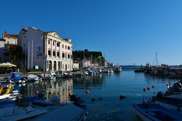 Fototapeta na wymiar Piran, Slovenia - May 10 2022: Bay in the town of Piran on the Adriatic coast in Slovenian Istria