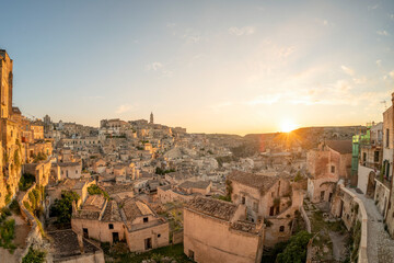 Fototapeta na wymiar Stunning view of the village of Matera during a beautiful sunrise. Matera is a city on a rocky outcrop in the region of Basilicata, in southern Italy.