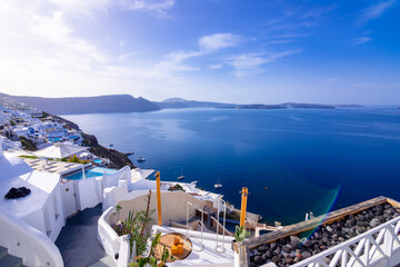 Fototapeta premium Oia town on Santorini island, Greece. Traditional and famous houses and churches with blue domes over the Caldera, Aegean sea