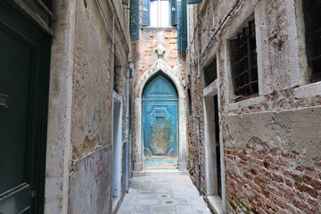 Fototapeta na wymiar La porte bleue. La porta blu. Vue typique d'une ruelle vénitienne. Venise. Italie.