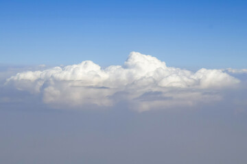 View of fluffy clouds from plane. Copy space. Close-up. Selective focus.