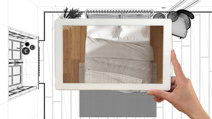 Augmented reality concept. Hand holding tablet with AR application used to simulate furniture products in custom architecture design, black ink sketch, bedroom. Top view, plan, above