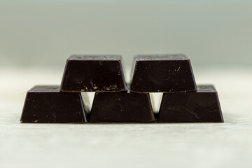 Pieces of dark chocolate on the table. Close-up.