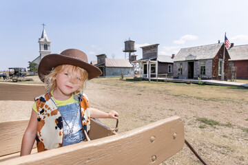 Child at the Wild West 1880's town in South Dakota playing dress up as a cowboy