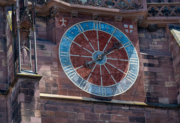 The old tower clock on the Freiburg Minster has only one clock hand and doesn‘t know the minutes. Baden-Wuerttemberg, Germany, Europe