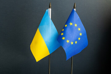 Flags of the countries of the European community and Ukraine on the mast next to each other,...
