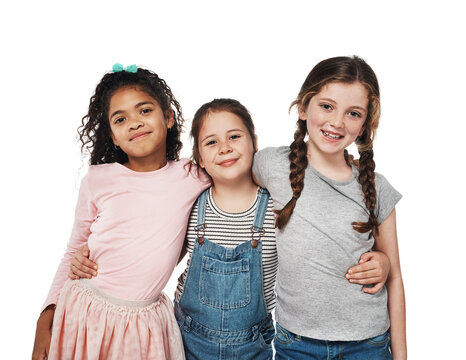 Friends like us are forever. Studio portrait of a group of three happy girls embracing one another against a white background.