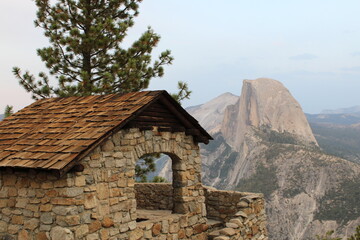 Fototapeta na wymiar Mountain Top Stone Monastery in Yosemite, with a view of Half Dome