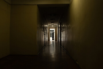 An old dark corridor is long in an office building in the city center in Ukraine, a door to the...