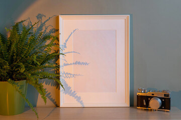 Blank frame mockup for artwork or print on green wall background.