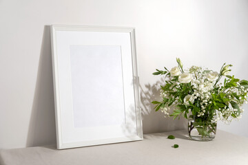 Blank frame mockup for artwork or print on white wall background.