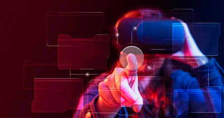 Young woman with virtual reality glasses pressing a button connected to different screens in cyber space