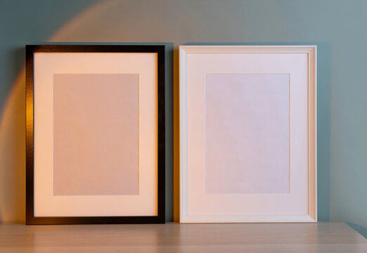 Blank frames mockup for artwork or print on green wall background.