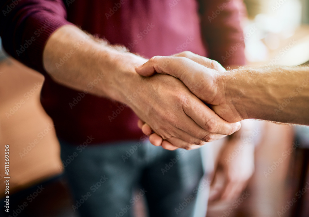 Poster heres to a successful project. closeup of two unrecognizable peoples hands greeting and shaking hand