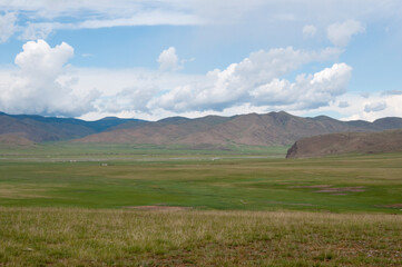 Awesome landscape in Central Mongolia. In the distance, ger or yurta, traditional mongolian tents