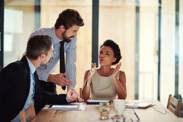 Creativity in action. Shot of a group of colleagues working together in an office.