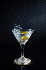 Delicious cocktail with alcohol served with garnish prepared by the bartender in the cocktail bar in dark colors