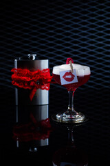 Delicious cocktail with alcohol served with garnish prepared by the bartender in the cocktail bar in dark colors