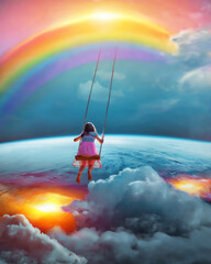 Child swinging from rainbow