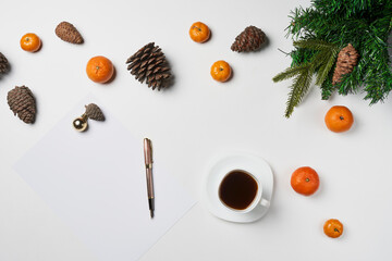 Christmas composition. Christmas frame with tangerines, fir and cup coffee on white table. Flat lay, top view
