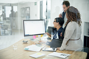 Getting a second and third opinion. Cropped shot of three colleagues working in the office.
