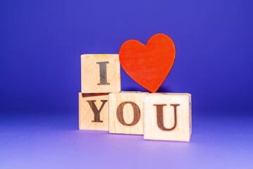 i love you text on wooden blocks heart. purple veri peri background.copy space.