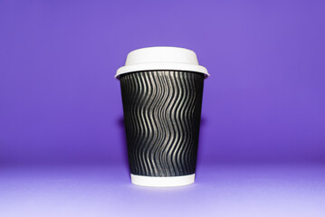 Beautiful Tea Coffee Juice Disposable Paper Cup in purple,veri peri blurred Background.