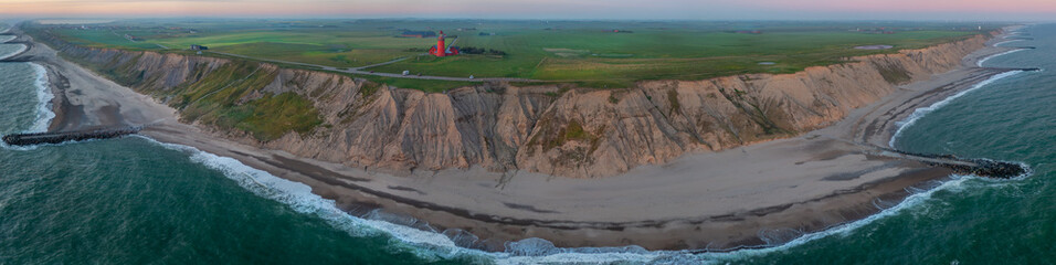 Scenic view of the cliffs at the danish coast with the red lighthouse Bovbjerg Fyr.  Panoramic aerial view of  beautiful nature landscape Danish North Sea coast, Jutland, Denmark, Europe