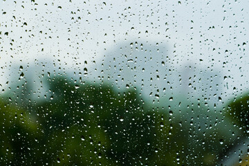 Blurred cityscape outside the window in the rain