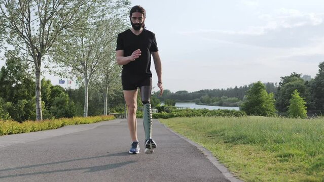 Fit young man with physical disability doing rehabilitation exercise routine outdoor