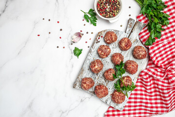 Raw meatballs minced pork meat with spices on a cutting board on a light background, Restaurant menu, dieting, cookbook recipe top view