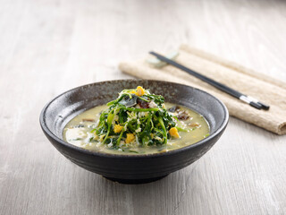 Poached Chinese Spinach with Egg Trio and Minced Pork with chopsticks served in a dish isolated on mat side view on grey background