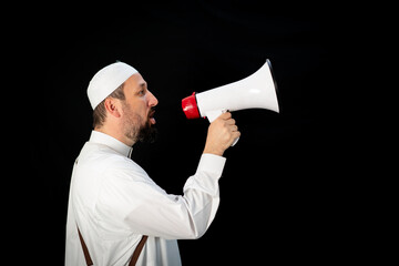 Handsome man with beard shouting through megaphone for Hajj in Mekkah