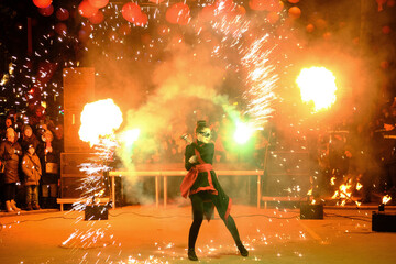 Fire show. theater of fire. Sparks, flames. Performance on the street for the public. Chinese New...