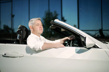 Handsome man in the convertible. Luxury life