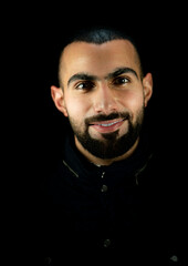 Portrait of young attractive man on a black background. High quality photo