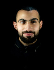 Portrait of young attractive man on a black background. High quality photo