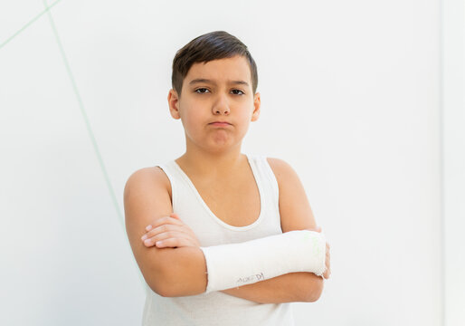 Boy keeps broken arm in gypsum, plaster arm, accident at home , injury, trauma concept. High quality photo