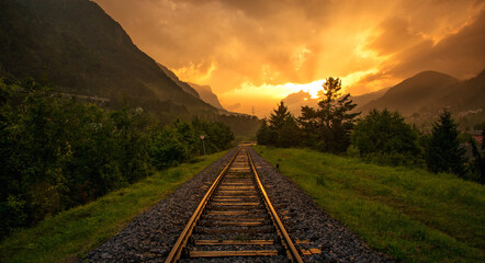 Evening and vivid sunset on the railroad tracks