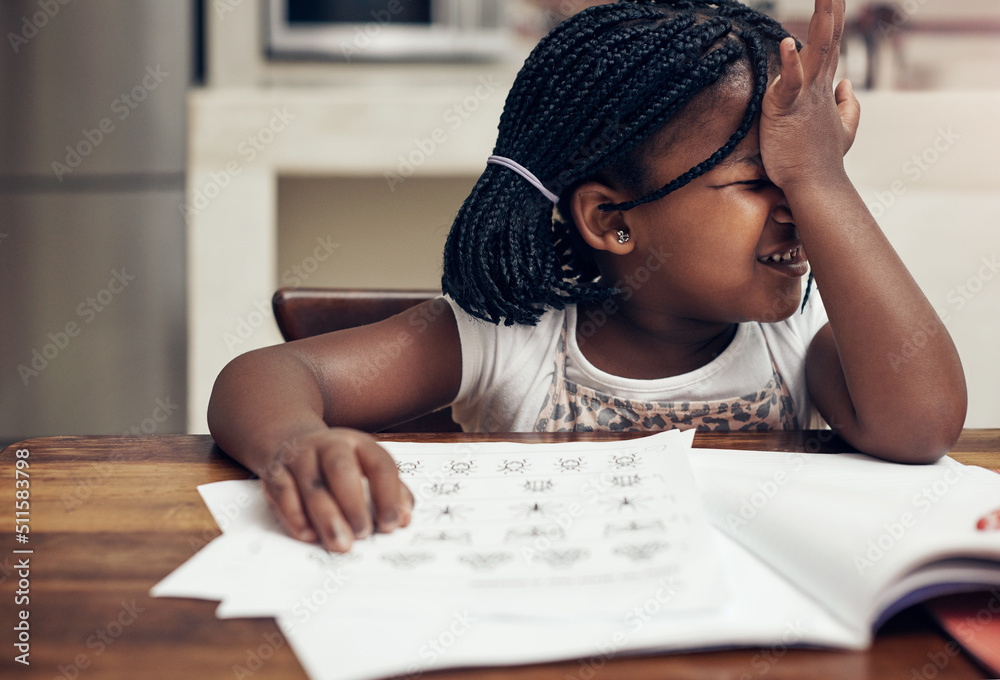 Wall mural This needs some careful thinking. Cropped shot of an adorable little girl thinking hard while doing her homework at home.