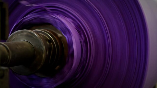 Purple Paper Reel Rolling at a Paper Machine in Pulp and Paper Mill Plant. Close Up. 4K Resolution.