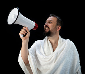 Handsome man with beard shouting through megaphone for Hajj in Mekkah