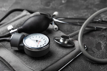 Black blood pressure monitor on a black marble background.Medical equipment blood pressure...